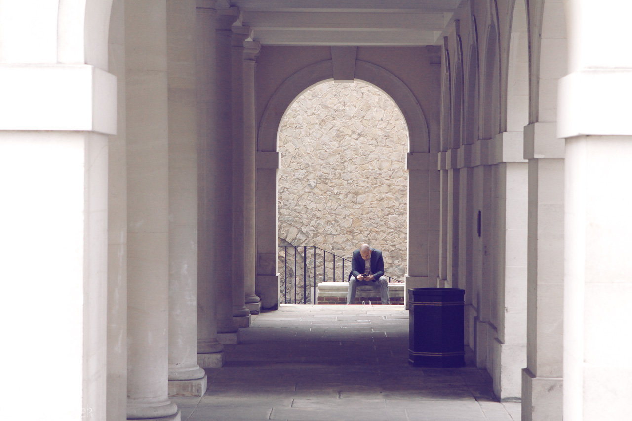Whispers of Westminster Foto von A solitary figure reflects in a stone archway in London, revealing the serene beauty of urban solitude.